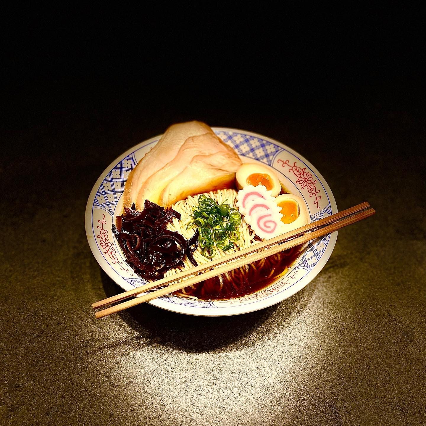 A bowl of ramen with chashu, egg and black fungus
