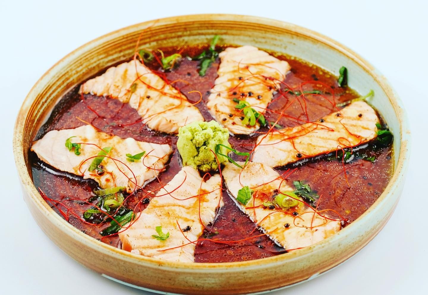 Thinly sliced seared fish with a citrus dressing